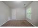 A bright bedroom featuring a door, window, neutral walls, trim, and carpeting at 2557 Woodford Ln, Buford, GA 30519