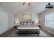 This virtually staged bedroom features a vaulted ceiling, plush carpet, and neutral colors at 2557 Woodford Ln, Buford, GA 30519