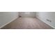 A spacious bedroom featuring neutral walls, trim, and carpeting at 2557 Woodford Ln, Buford, GA 30519