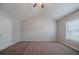 Bright bedroom showcases a neutral color scheme, soft carpeting, and a vaulted ceiling at 2557 Woodford Ln, Buford, GA 30519