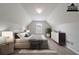 Virtually staged bedroom showcasing sloped ceilings and contemporary furnishings at 2557 Woodford Ln, Buford, GA 30519