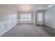 Bright dining room featuring neutral paint, carpet flooring, and natural light from a large window at 2557 Woodford Ln, Buford, GA 30519