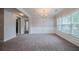 Inviting dining room featuring carpet, wainscoting, a modern chandelier, and natural light at 2557 Woodford Ln, Buford, GA 30519