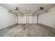 An empty two-car garage featuring two garage doors and ceiling hardware at 2557 Woodford Ln, Buford, GA 30519