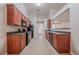 Functional kitchen featuring cherry wood cabinets, black appliances, and an open layout for easy entertaining at 2557 Woodford Ln, Buford, GA 30519