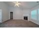 Cozy living room featuring a fireplace, neutral walls, plush carpeting, and ample natural light at 2557 Woodford Ln, Buford, GA 30519