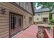 Backyard wooden deck with stone pillars and an exterior view of the home at 3044 Dogwood Dr, Atlanta, GA 30354