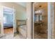 Bathroom featuring a soaking tub with tile surround, a glass shower enclosure, and a view into the main bedroom at 3044 Dogwood Dr, Atlanta, GA 30354