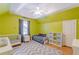 Brightly painted upstairs bedroom with hardwood floors, ceiling fan, and a chevron patterned rug at 3044 Dogwood Dr, Atlanta, GA 30354