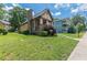 Charming home with stone chimney and a covered front porch, nestled in a well-maintained yard at 3044 Dogwood Dr, Atlanta, GA 30354
