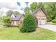 Exterior of a charming home featuring manicured landscaping and a detached two-car garage at 3044 Dogwood Dr, Atlanta, GA 30354