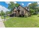 Charming home with manicured front lawn, lush shrubbery, and inviting porch at 3044 Dogwood Dr, Atlanta, GA 30354