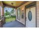 Inviting front porch with stone accents, wood flooring, and a decorative glass front door at 3044 Dogwood Dr, Atlanta, GA 30354