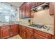Gas cooktop and granite countertops in a kitchen with cherry cabinets at 3044 Dogwood Dr, Atlanta, GA 30354