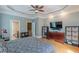 Spacious main bedroom features trey ceilings, hardwood floors, and an ensuite bathroom with a large flat screen television at 3044 Dogwood Dr, Atlanta, GA 30354