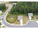 An aerial shot showcases the home's location within a lush, green neighborhood with mature trees at 165 Brookstone E Park, Acworth, GA 30101