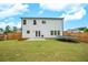 Fenced backyard with well-maintained lawn, patio, and a trampoline, ideal for Gathering fun at 165 Brookstone E Park, Acworth, GA 30101