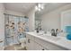 Bright bathroom featuring a double vanity, stylish lighting, and a fun, themed shower curtain at 165 Brookstone E Park, Acworth, GA 30101