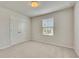 Bright bedroom featuring neutral carpeting, a double door closet, and a window with natural light at 165 Brookstone E Park, Acworth, GA 30101