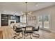 Chic dining area with modern lighting fixture, glass table and seating for six, with access to the backyard at 165 Brookstone E Park, Acworth, GA 30101