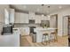 Bright kitchen with white cabinets, stainless steel appliances, an island with seating, and a walk-in pantry at 165 Brookstone E Park, Acworth, GA 30101