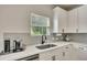 Clean kitchen featuring white countertops, herringbone backsplash, modern appliances, and ample cabinet space at 165 Brookstone E Park, Acworth, GA 30101