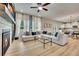 Bright living room featuring a fireplace, large sectional, and an open floor plan leading to the kitchen and dining area at 165 Brookstone E Park, Acworth, GA 30101