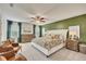 Serene main bedroom with a king-sized bed, sitting area, and windows providing plenty of natural light at 165 Brookstone E Park, Acworth, GA 30101