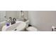 Simple and functional powder room featuring a pedestal sink, mirror, and toilet with neutral wall color at 165 Brookstone E Park, Acworth, GA 30101