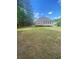 Expansive backyard featuring green lawn and mature trees provides privacy at 1669 Azalea Dr, Lawrenceville, GA 30043