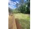 Backyard view from wooden deck showing lawn and garden beds at 1669 Azalea Dr, Lawrenceville, GA 30043
