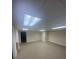Finished basement space with fluorescent lights and wall heater, perfect for a variety of uses at 1669 Azalea Dr, Lawrenceville, GA 30043