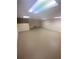 Spacious unfinished basement featuring concrete flooring and fluorescent lighting at 1669 Azalea Dr, Lawrenceville, GA 30043