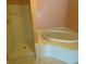 Well-lit bathroom features tile floors, tub, and separate shower at 1669 Azalea Dr, Lawrenceville, GA 30043