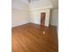 Large bedroom with hardwood floors and view into the hall at 1669 Azalea Dr, Lawrenceville, GA 30043