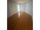 A clean bedroom features hardwood flooring, neutral walls, and a closet for storage at 1669 Azalea Dr, Lawrenceville, GA 30043