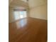 Spacious bedroom with hardwood floors, fan, and large windows at 1669 Azalea Dr, Lawrenceville, GA 30043