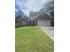 Charming brick home with a well-maintained lawn and attached two-car garage, perfect for suburban living at 1669 Azalea Dr, Lawrenceville, GA 30043