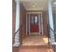 Close-up of the front door showcasing the elegant design, sidelights, decorative columns, and covered porch at 1669 Azalea Dr, Lawrenceville, GA 30043