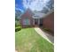 Inviting front entrance with brick facade, landscaped garden, and a covered porch leading to the front door at 1669 Azalea Dr, Lawrenceville, GA 30043