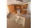Traditional eat-in kitchen features wood cabinets, tile floors and double bowl sink at 1669 Azalea Dr, Lawrenceville, GA 30043