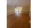 Bright living room featuring hardwood floors, a neutral color scheme, and an open layout connected to the dining area at 1669 Azalea Dr, Lawrenceville, GA 30043