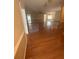 Spacious open-concept living room with hardwood floors, natural light, and seamless flow into the dining area at 1669 Azalea Dr, Lawrenceville, GA 30043