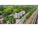Aerial view of modern townhomes near train tracks and lush greenery at 1672 Dekalb Ne Ave # 2, Atlanta, GA 30307