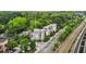 Aerial view of modern townhomes near train tracks and lush greenery at 1672 Dekalb Ne Ave # 2, Atlanta, GA 30307