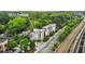 A daytime aerial view showcases the property at 1672 Dekalb and the surrounding landscape and train tracks at 1672 Dekalb Ne Ave # 2, Atlanta, GA 30307
