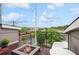 Balcony with a modern fire pit and city views, surrounded by lush trees and a blue sky backdrop at 1672 Dekalb Ne Ave # 2, Atlanta, GA 30307