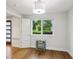 Bright bedroom with hardwood flooring and large window overlooking lush greenery at 1672 Dekalb Ne Ave # 2, Atlanta, GA 30307