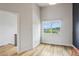 Bright bedroom featuring light hardwood floors and a large window with green scenery at 1672 Dekalb Ne Ave # 2, Atlanta, GA 30307
