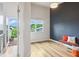 Bright bedroom with a modern accent wall, access to a balcony, and natural light through a large window at 1672 Dekalb Ne Ave # 2, Atlanta, GA 30307
